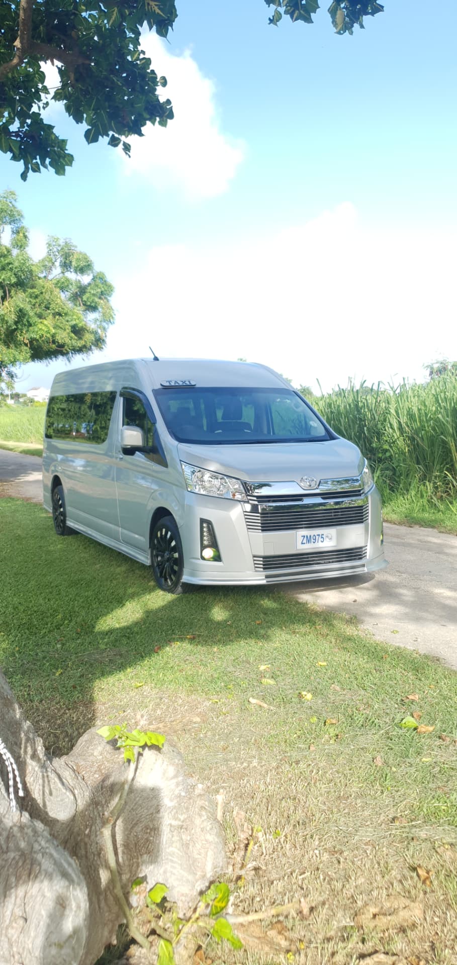 Silver Toyota luxury van parked on a Barbados country road